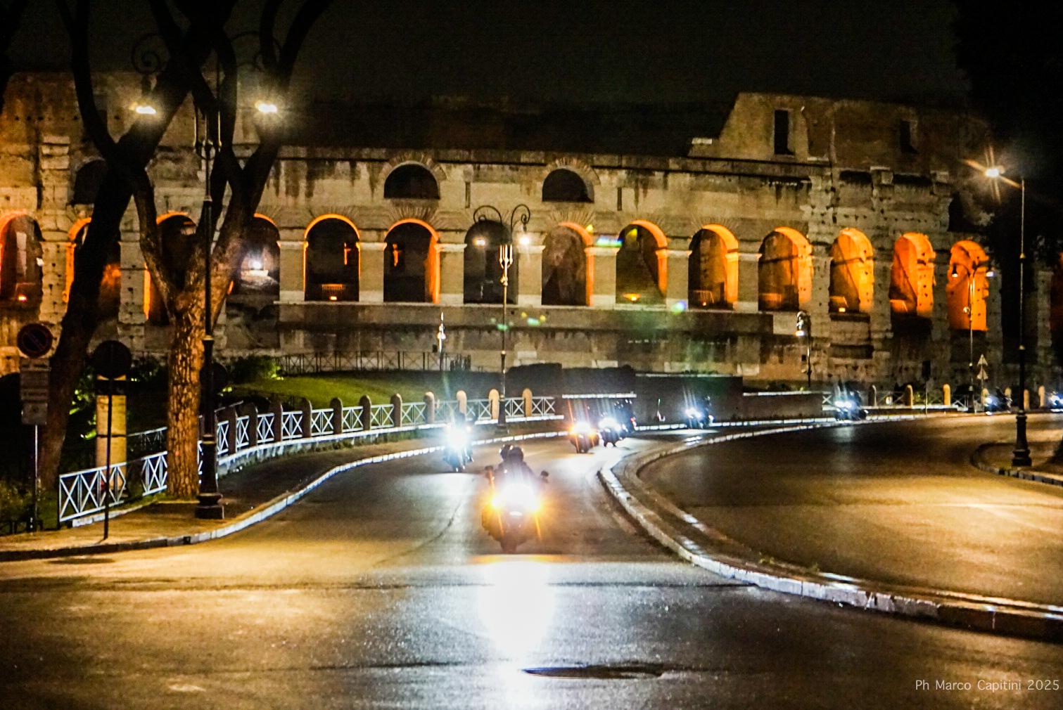 Biker riding through Rome at sunset